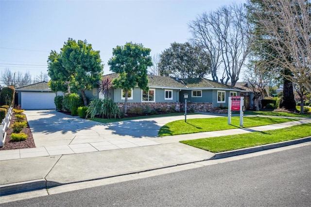 ranch-style home with a garage and a front yard