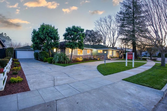 ranch-style house with a yard and a garage