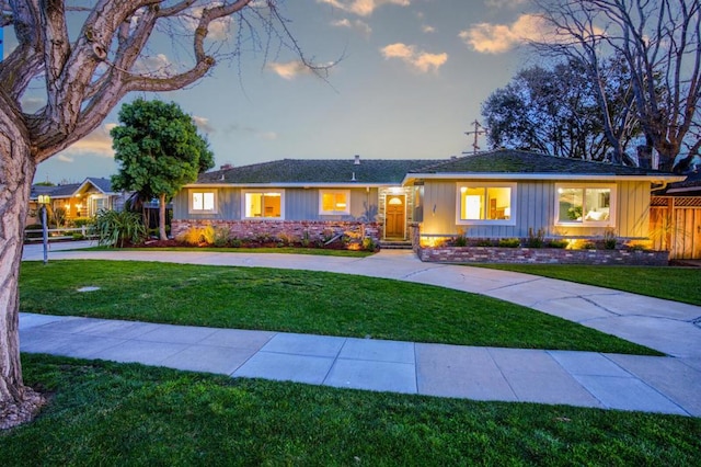 ranch-style home featuring a lawn