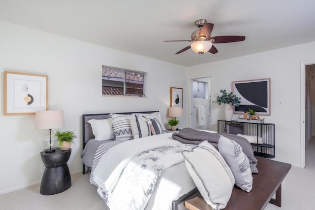 carpeted bedroom featuring ensuite bath and ceiling fan