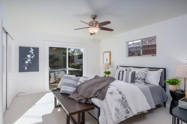 carpeted bedroom featuring ceiling fan and access to exterior