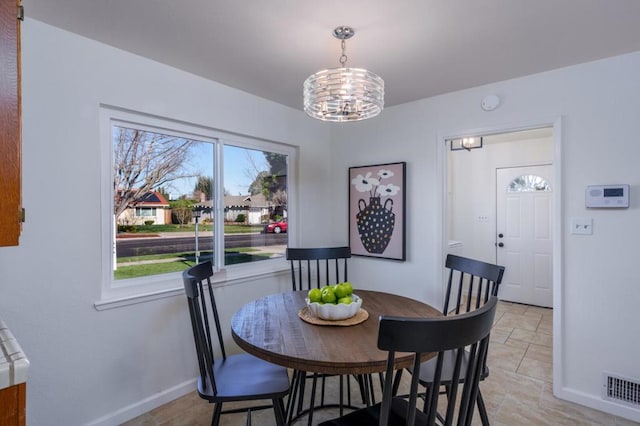 dining area featuring an inviting chandelier