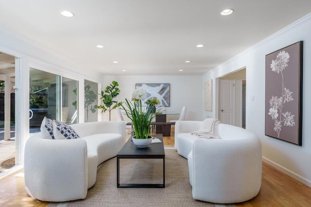 living room featuring hardwood / wood-style flooring and ornamental molding