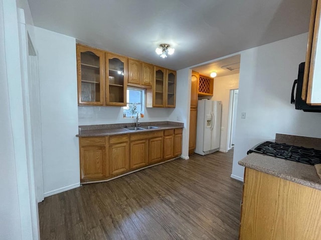 kitchen featuring white refrigerator with ice dispenser, sink, and dark hardwood / wood-style flooring