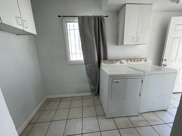 laundry room with separate washer and dryer, cabinets, and light tile patterned flooring