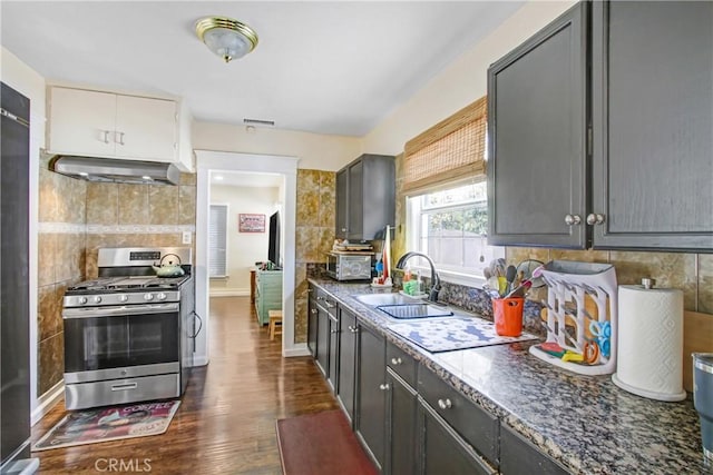 kitchen featuring sink, stainless steel gas range, range hood, and gray cabinets