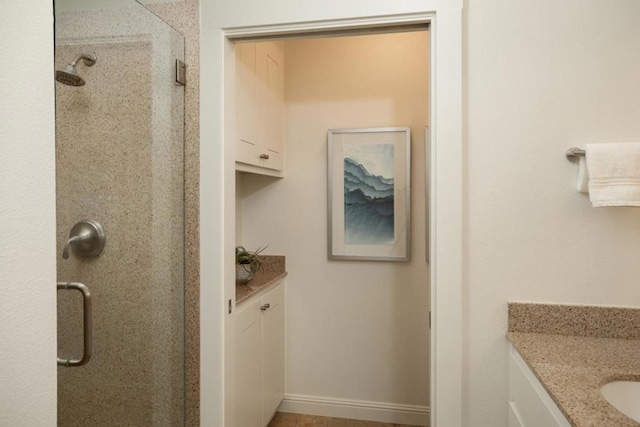 bathroom featuring walk in shower and vanity