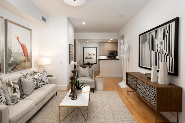 living room with light hardwood / wood-style flooring