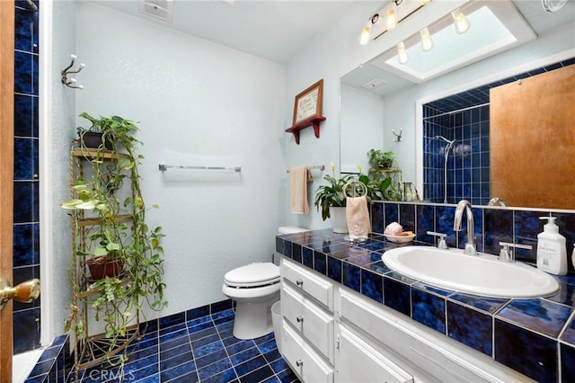 bathroom featuring walk in shower, tile patterned floors, vanity, and toilet