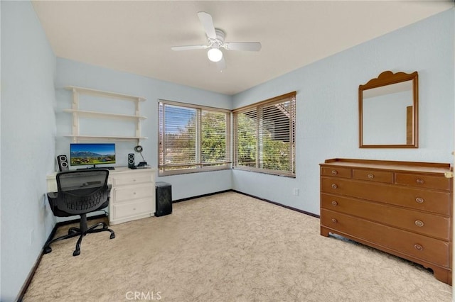 office space featuring light carpet and ceiling fan