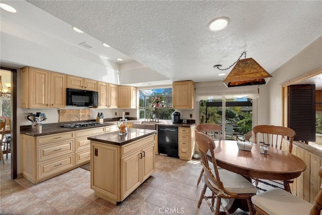 kitchen with a kitchen island, sink, black appliances, light brown cabinets, and a textured ceiling