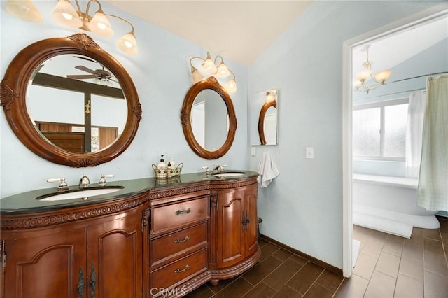 bathroom featuring vanity, a chandelier, and vaulted ceiling