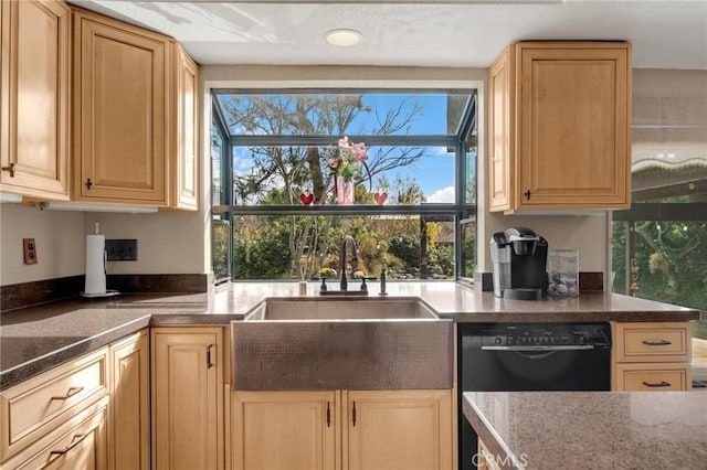 kitchen featuring light brown cabinetry, sink, dark stone counters, and dishwasher