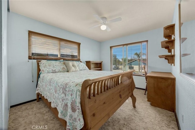 bedroom featuring ceiling fan and light carpet