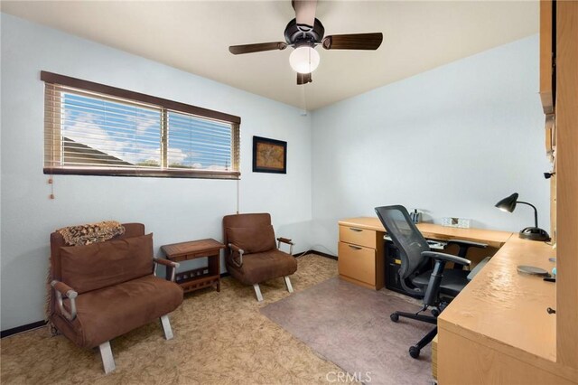 office space featuring light carpet and ceiling fan