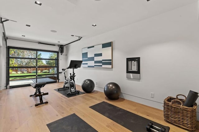 exercise room with hardwood / wood-style floors