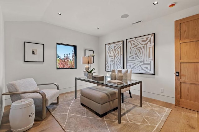 home office featuring vaulted ceiling and hardwood / wood-style floors