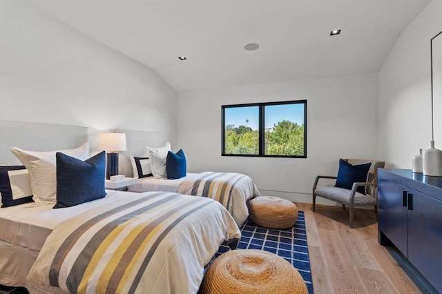 bedroom featuring lofted ceiling and wood-type flooring