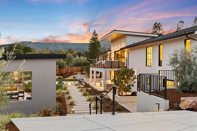 exterior space with a patio, a balcony, and a mountain view