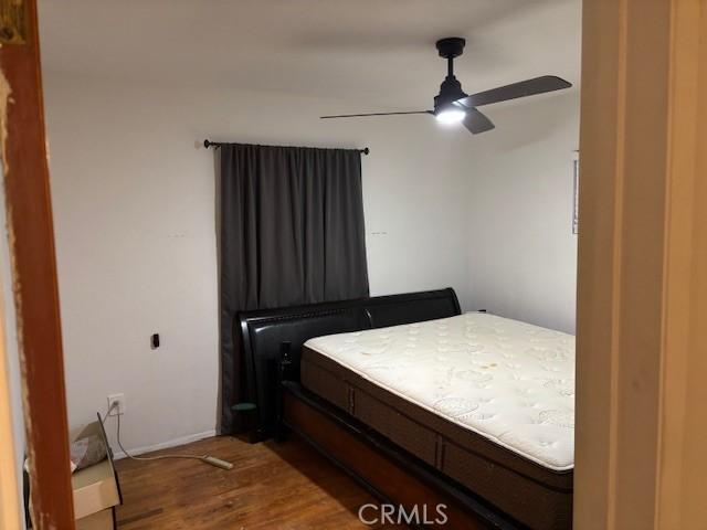 bedroom featuring wood-type flooring and ceiling fan