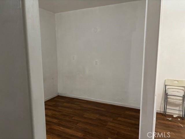 empty room with dark hardwood / wood-style floors