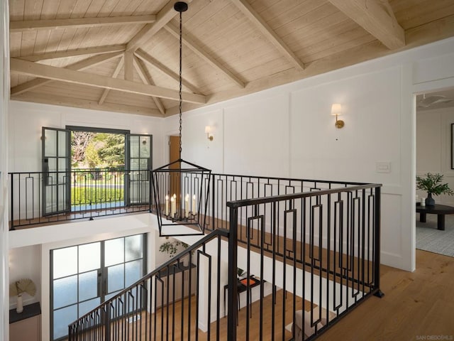 corridor featuring hardwood / wood-style floors, lofted ceiling with beams, and wooden ceiling