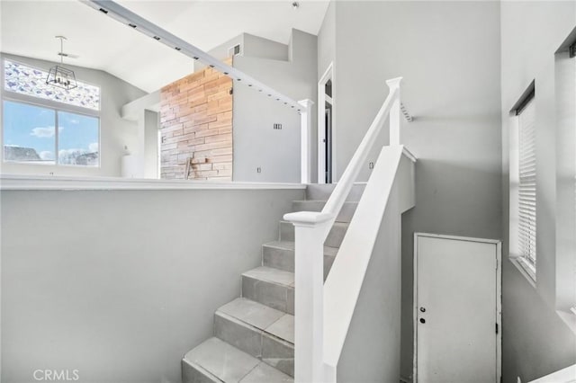 stairway featuring vaulted ceiling