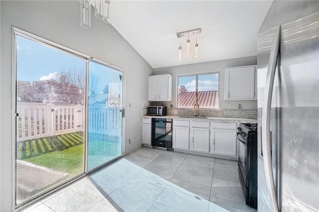 kitchen with stainless steel appliances, white cabinetry, and wine cooler