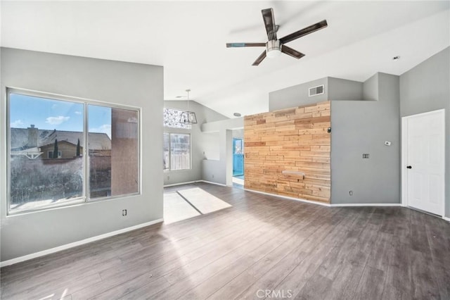 unfurnished living room with lofted ceiling, dark hardwood / wood-style floors, and ceiling fan