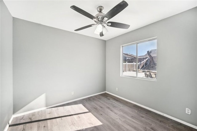 unfurnished room featuring ceiling fan and dark hardwood / wood-style floors