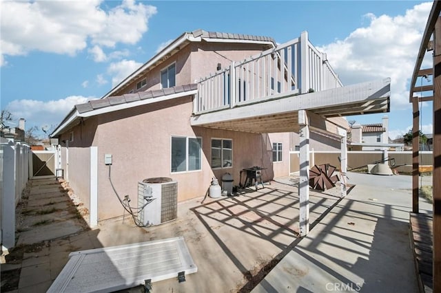 back of house with central AC unit and a patio area