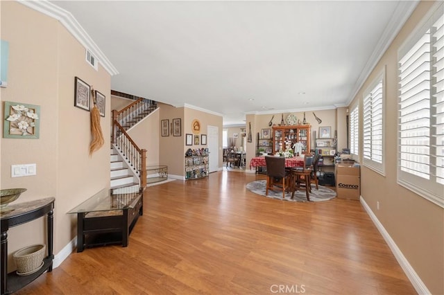 interior space featuring ornamental molding and light hardwood / wood-style floors