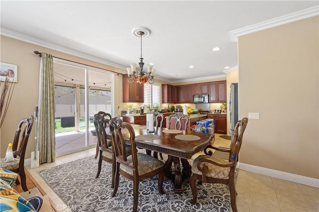 tiled dining area with crown molding and an inviting chandelier