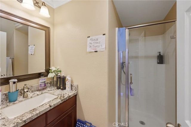 bathroom with vanity and a shower with door