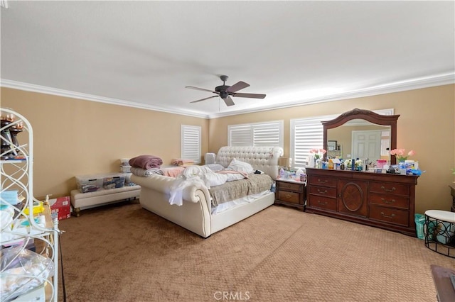 bedroom featuring ornamental molding, light colored carpet, and ceiling fan