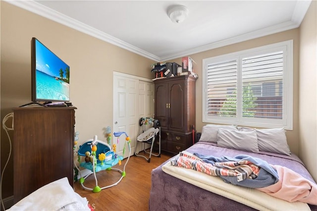 bedroom with hardwood / wood-style flooring and ornamental molding