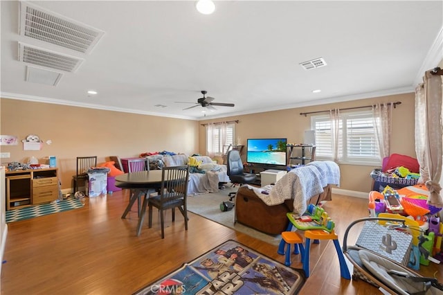 living room with crown molding, ceiling fan, and light hardwood / wood-style floors