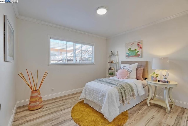 bedroom featuring crown molding and light wood-type flooring