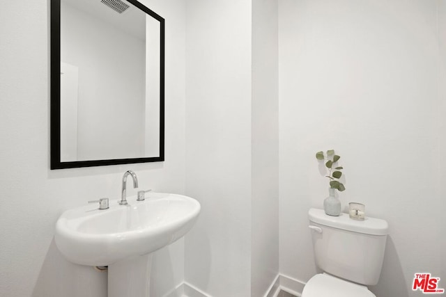 bathroom featuring sink and toilet