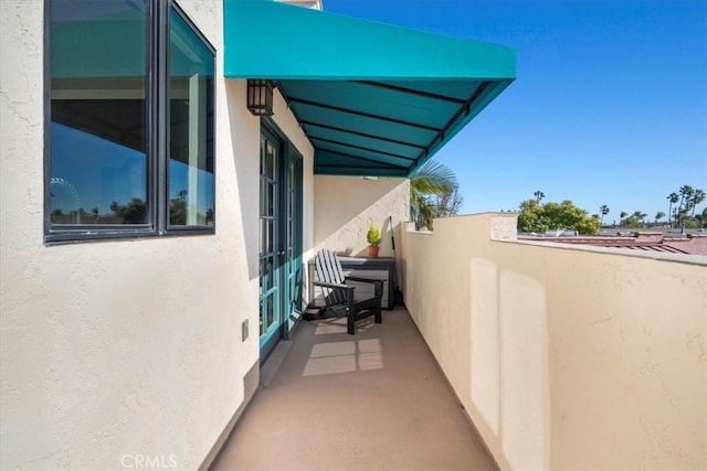 view of home's exterior featuring a balcony and stucco siding