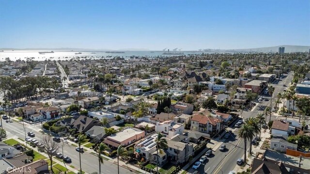 birds eye view of property with a water view and a residential view