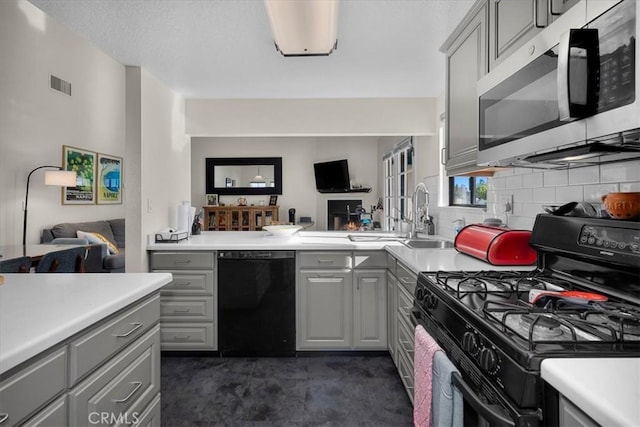 kitchen featuring visible vents, open floor plan, gray cabinets, light countertops, and black appliances