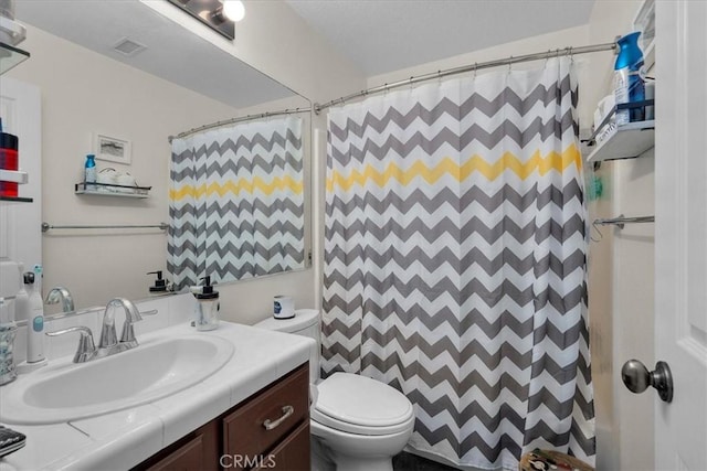 full bath with visible vents, vanity, and toilet