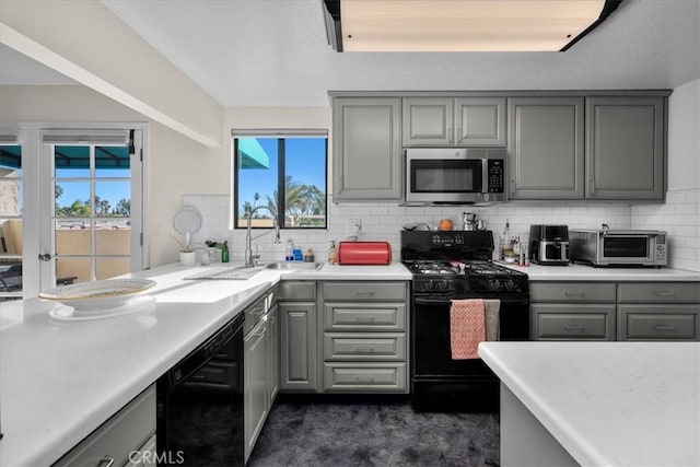 kitchen featuring black appliances, light countertops, and gray cabinetry