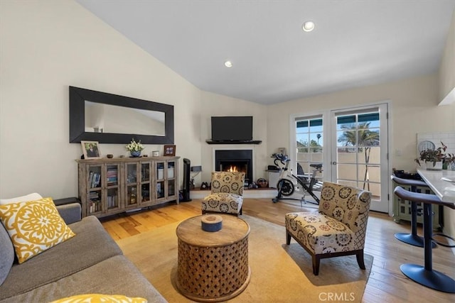 243 Park Ave, Long Beach, CA 90803 - living room with wood finished floors, vaulted ceiling, a lit fireplace, and recessed lighting