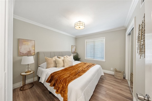 bedroom with hardwood / wood-style flooring and crown molding