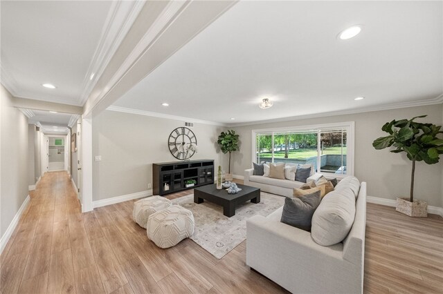 living room featuring crown molding and light wood-type flooring