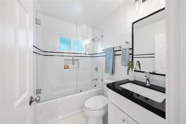 full bathroom featuring vanity, tile walls, enclosed tub / shower combo, and toilet