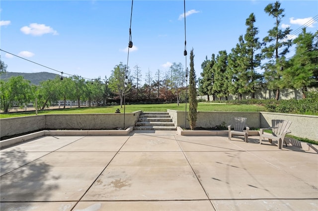 surrounding community featuring a patio and a mountain view