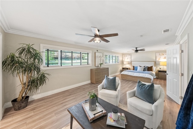 bedroom with multiple windows, ornamental molding, ceiling fan, and light wood-type flooring